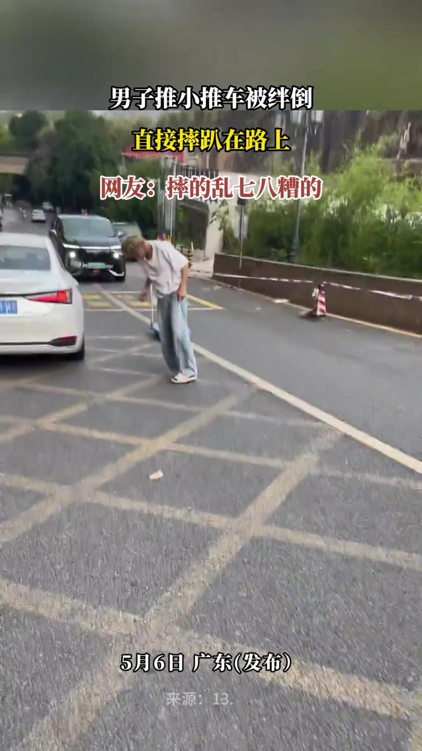 男子推小推车被绊倒 直接摔趴在路上