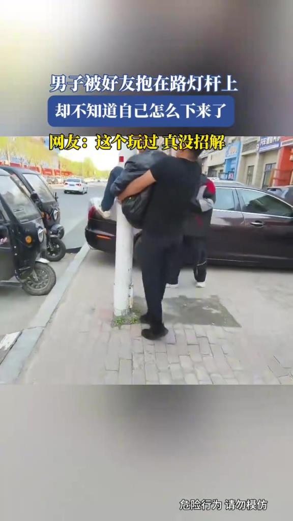 男子被好友抱在路燈桿上，卻不知道自己怎么下來了