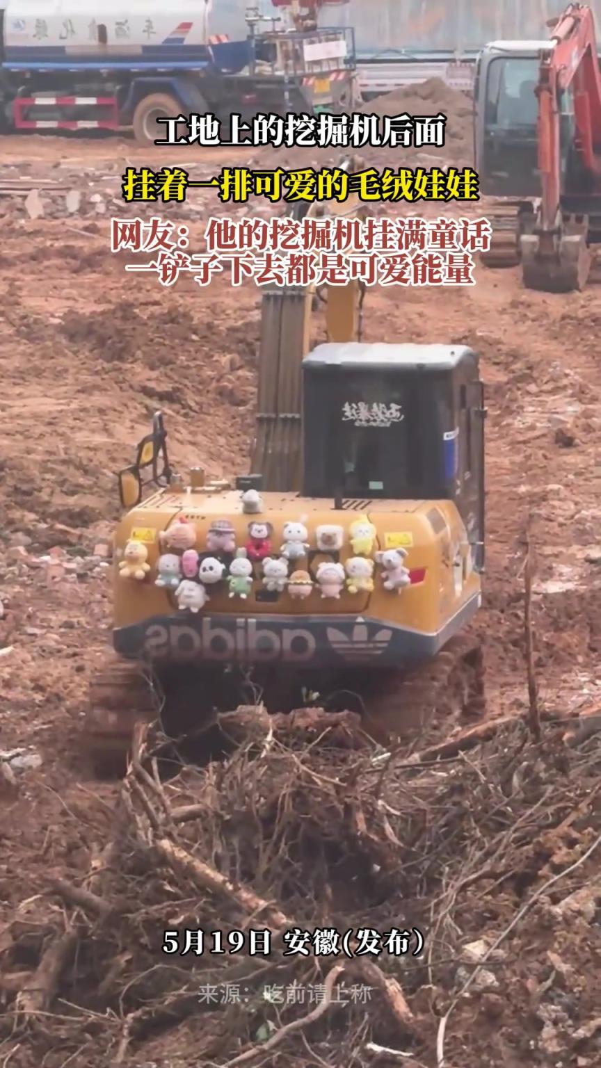 工地上的挖掘机后面，挂着一排可爱的毛绒娃娃