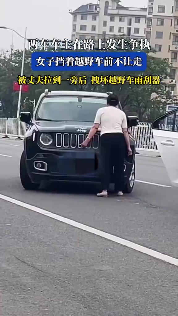 两车车主在路上发生争执 女子挡着越野车前不让走