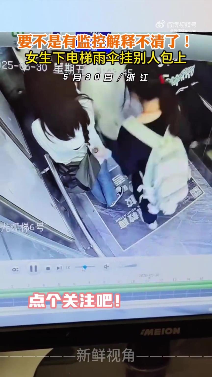 要不是有监控解释不清了！女生下电梯雨伞挂别人包上!